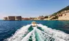 Speedboat leaving Dubrovnik Old Town harbor. Explore the Adriatic with Tendo.