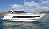 Luxurious yacht cruising along Dubrovnik's coastline, offering stunning views of the Adriatic Sea and nearby mountains.