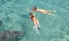 Two people snorkeling in crystal-clear turquoise waters near Blue Cave on a sunny day. Price From : €216.00