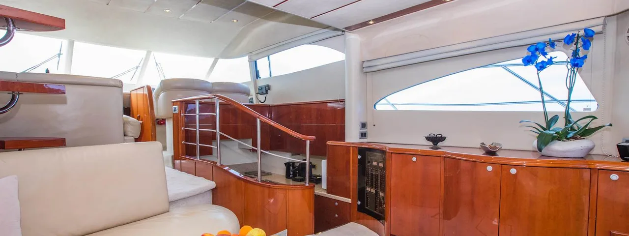 Luxury yacht interior: Elegant cabin with polished wood finishes, comfortable seating, and fresh fruit platter for Dubrovnik boat tours