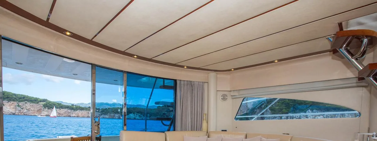 Luxurious yacht interior with panoramic sea view, comfortable seating area, and elegant furnishings for a premium Dubrovnik cruise experience.