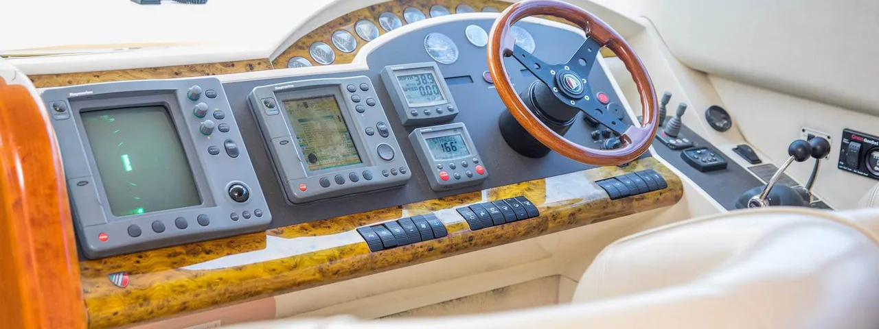 Luxury yacht control panel with modern navigation equipment and wooden steering wheel, ready for Dubrovnik Private Boat Tours