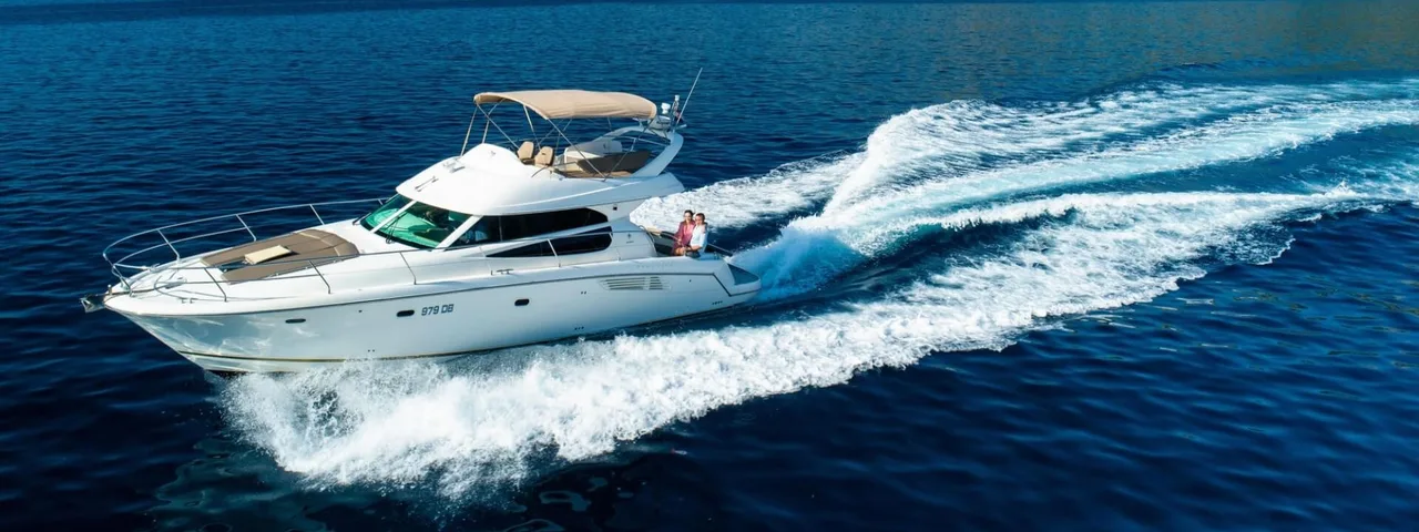 Luxury yacht cruising along Croatian coast near Dubrovnik, with Elaphiti islands and clear blue Adriatic Sea in background