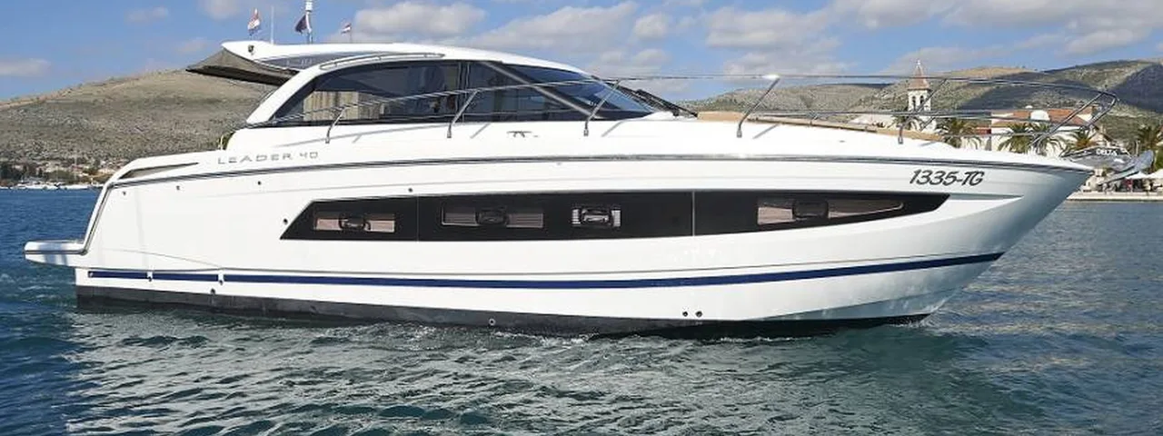 Sleek white Leader 40 luxury yacht cruising the Adriatic Sea near Trogir, offering bespoke private boat tours on the Dalmatian Coast.