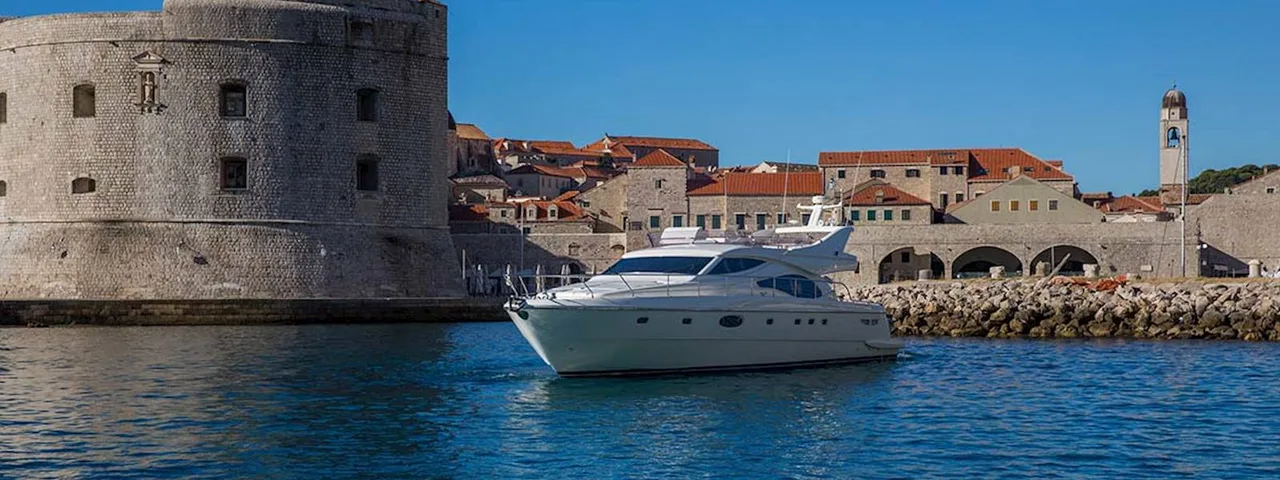 Luxury yacht tour departing from Dubrovnik old town harbor, Croatia.