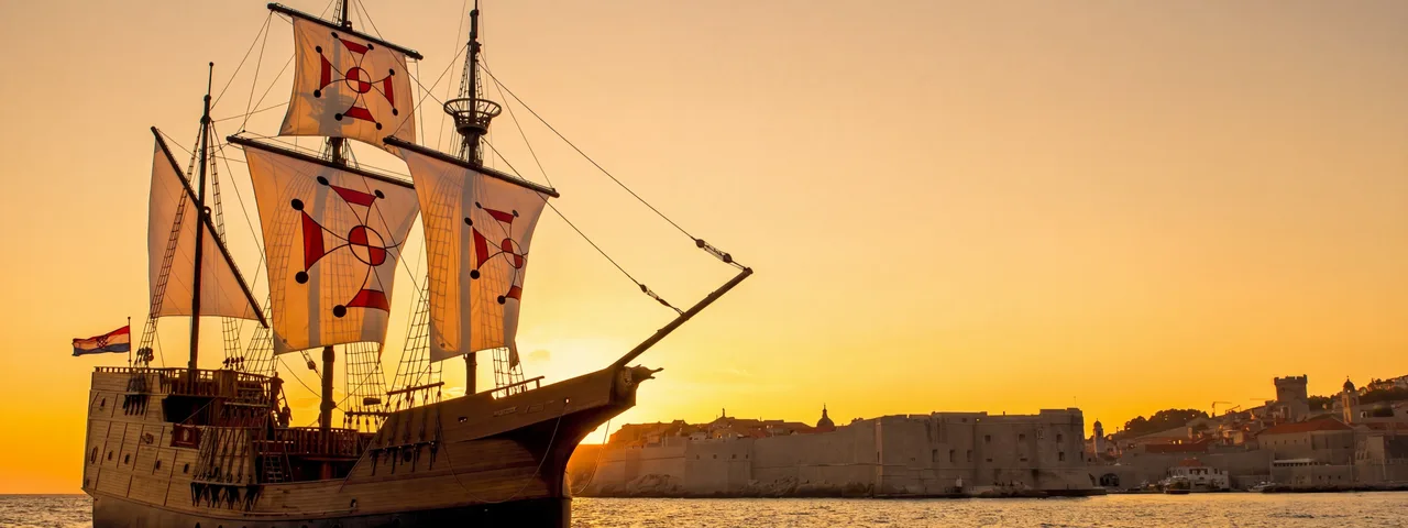 Dubrovnik luxury event ship sailing at sunset beside the Old Town city walls