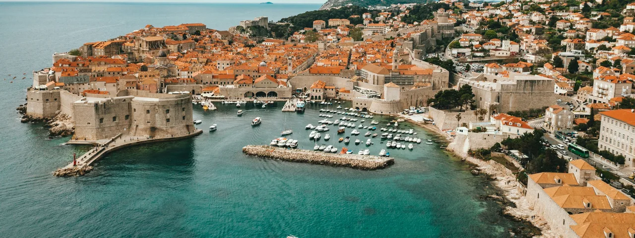 Marble-paved Stradun main street of Dubrovnik Old Town lined with baroque buildings and lively pedestrians, Croatia