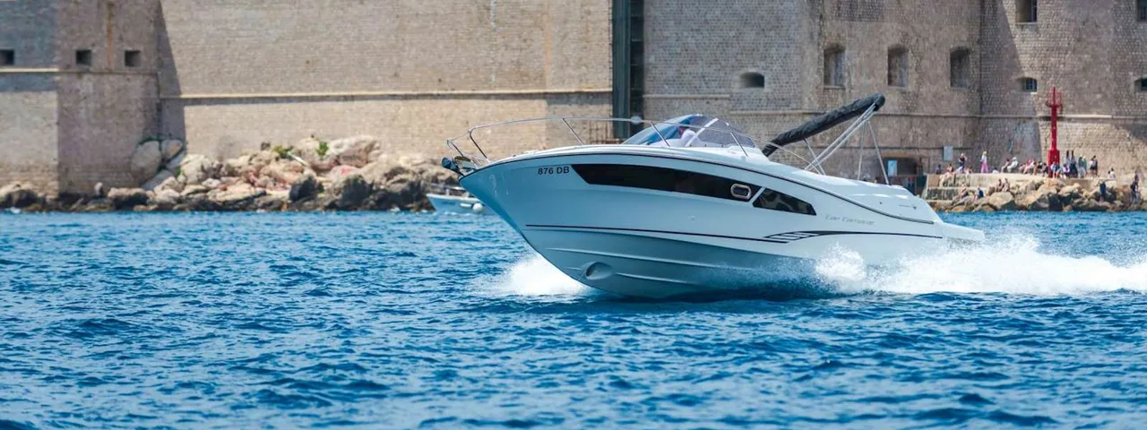 Explore Dubrovnik by boat. Speed boat Jeanneau Cap Camarat 9 Dubrovnik Old Town walls