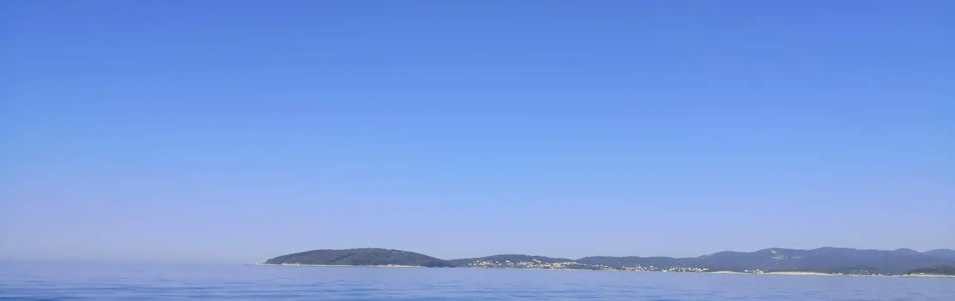On the way from Dubrovnik to Hvar experience calm blue sea with distant islands on horizon under clear sky