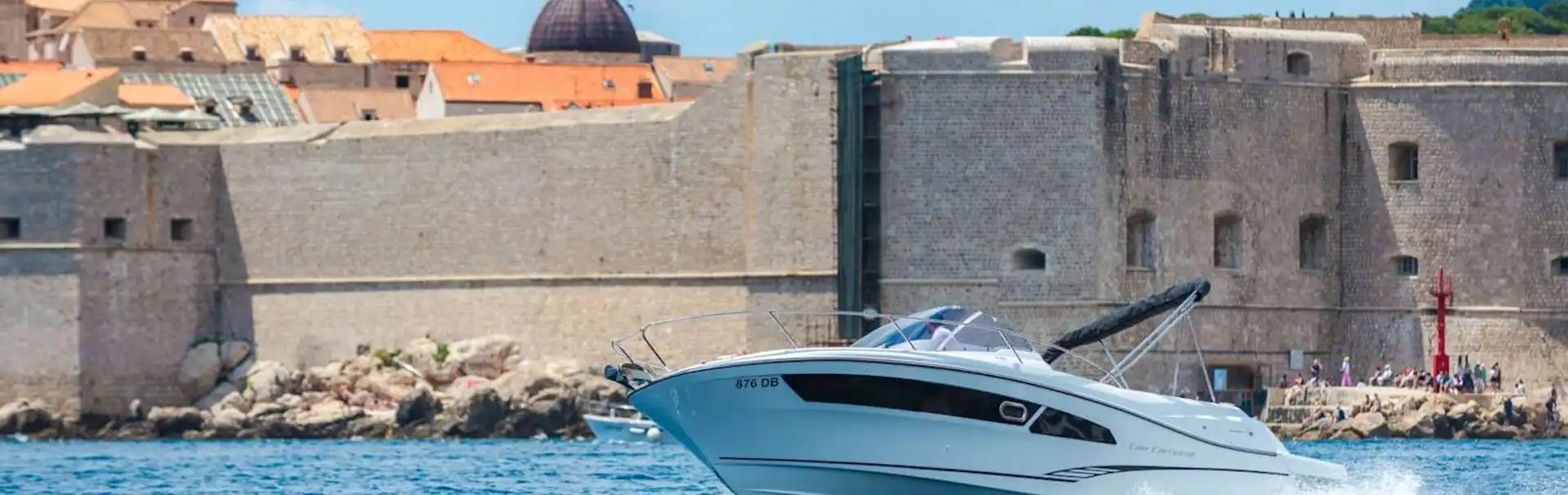 Explore Dubrovnik by boat. Speed boat Jeanneau Cap Camarat 9 Dubrovnik Old Town walls