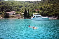 Client enjoying a swim and snorkel in Marculeti Bay, Peljesac Island, during their private yacht charter.
