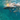 Underwater view of snorkeler exploring crystal-clear turquoise waters, surrounded by sunlight and bubbles.