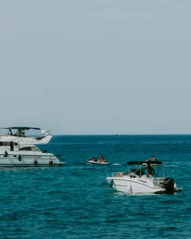 Private speedboat and motor yacht with jet ski on the deep-blue Adriatic off Budva, Montenegro