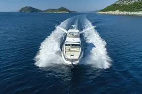 Azimut 66 Fly luxury yacht cruising the Adriatic Sea near Dubrovnik, leaving a powerful wake under a clear sky.