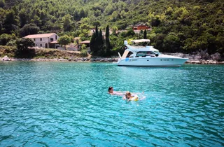 Client enjoying a swim and snorkel in Marculeti Bay, Peljesac Island, during their private yacht charter.