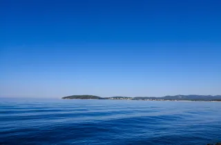 On the way from Dubrovnik to Hvar experience calm blue sea with distant islands on horizon under clear sky