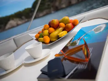 Relax on deck with panoramic views of rocky coastlines and hidden coves and plan your next adventure with our curated travel brochures