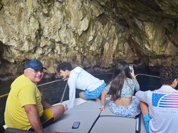 Family explores stunning sea cave near Dubrovnik on a Tendo luxury boat tour.