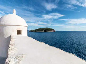 Dubrovnik city walls and Lokrum Island viewed from the Adriatic — private boat tour departure from Dubrovnik
