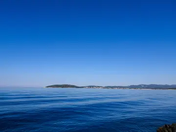 On the way from Dubrovnik to Hvar experience calm blue sea with distant islands on horizon under clear sky