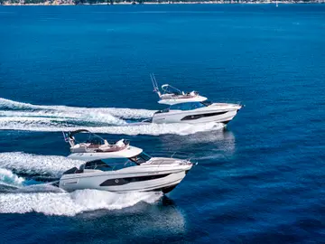 White luxury motor yachts speeding on the azure Adriatic Sea, perfect for a bespoke charter adventure along the Croatian coast.