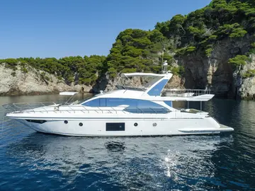 Azimut 66 Fly luxury yacht anchored in a secluded turquoise cove along the Adriatic coast, perfect for premium charters from Dubrovnik.