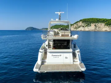 Luxury Azimut 66 Fly yacht 'Tamara II' stern, featuring its swim platform and flybridge on the sparkling Adriatic Sea near Dubrovnik.
