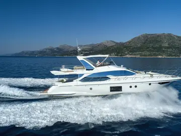 Azimut 66 Fly luxury yacht underway on the blue Adriatic Sea near Dubrovnik, showcasing sleek design and flybridge.