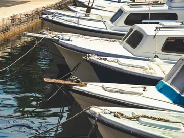 Traditional boats docked in the picturesque Milna harbor on Brač Island, a tranquil stop on luxury yacht charters from Split.