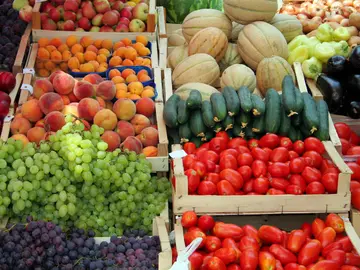 Colourful fresh produce market stall with green grapes, tomatoes, peppers and summer fruit at a Dalmatian outdoor market, Croatia