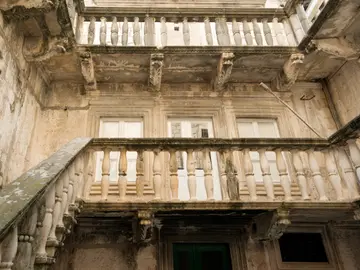 Renaissance stone facade of Marco Polo House in Korčula old town with ornate balustrades, carved friezes and arched windows