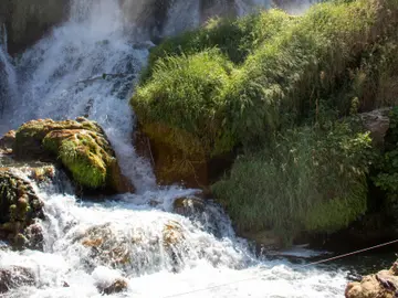 Kravice Waterfalls cascading over travertine cliffs into the Trebižat river pool, Bosnia