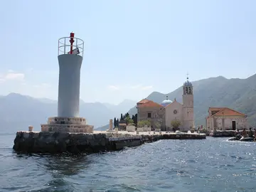 Our Lady of the Rocks church and lighthouse on a man-made islet off Perast in the Bay of Kotor, Montenegro