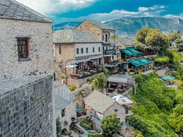 Aerial view of Mostar old town with Stari Most bridge, Neretva river and surrounding mountains