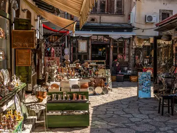 Narrow Ottoman-era market street in Baščaršija old town Sarajevo lined with souvenir and coppersmith stalls, Bosnia