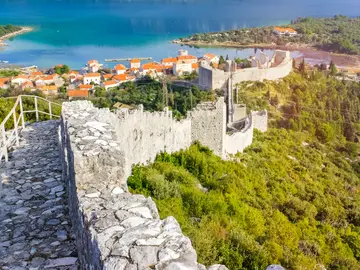 View from atop the Ston walls along the ancient battlements with village rooftops and Mali Ston Bay visible below, Dalmatia, Croatia