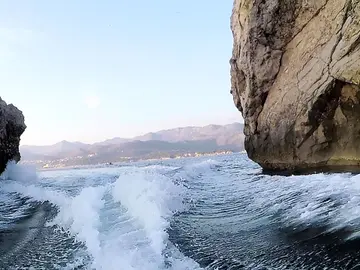 Scenic boat journey through rocky coastal formations near Dubrovnik, showcasing crystal-clear Adriatic waters