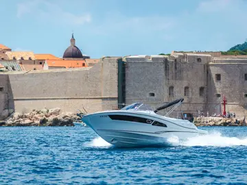 Explore Dubrovnik by boat. Speed boat Jeanneau Cap Camarat 9 Dubrovnik Old Town walls