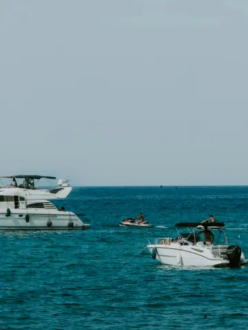 Private speedboat and motor yacht with jet ski on the deep-blue Adriatic off Budva, Montenegro