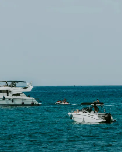 Private speedboat and motor yacht with jet ski on the deep-blue Adriatic off Budva, Montenegro