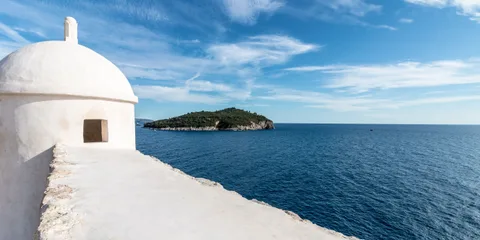 Dubrovnik city walls and Lokrum Island viewed from the Adriatic — private boat tour departure from Dubrovnik