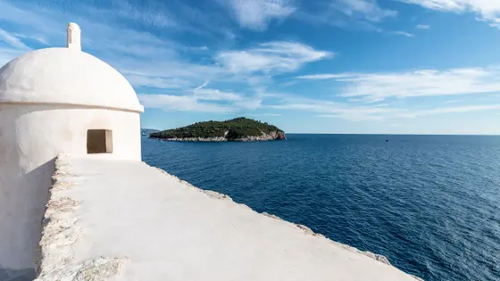 Dubrovnik city walls and Lokrum Island viewed from the Adriatic — private boat tour departure from Dubrovnik