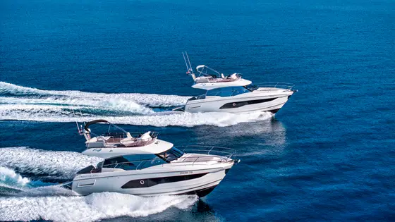 White luxury motor yachts speeding on the azure Adriatic Sea, perfect for a bespoke charter adventure along the Croatian coast.