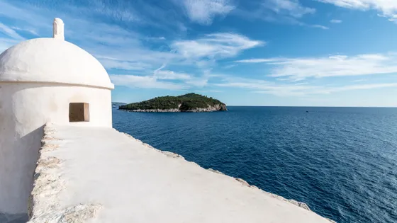 Dubrovnik city walls and Lokrum Island viewed from the Adriatic — private boat tour departure from Dubrovnik