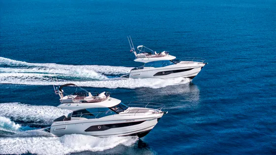White luxury motor yachts speeding on the azure Adriatic Sea, perfect for a bespoke charter adventure along the Croatian coast.