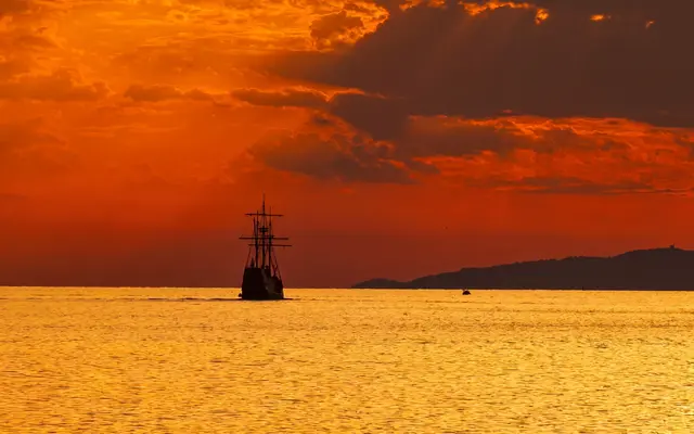 Panoramic sunset view of a Dubrovnik luxury event ship on the Adriatic horizon
