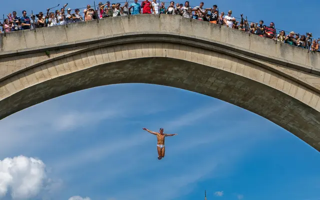Divers jumping off Stari Most bridge into the Neretva River in Mostar, Bosnia and Herzegovina