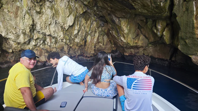 Family explores stunning sea cave near Dubrovnik on a Tendo luxury boat tour. 