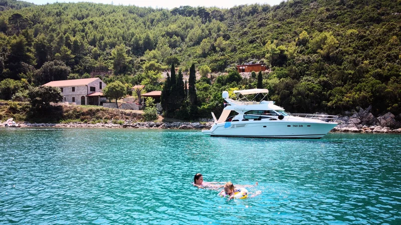 Client enjoying a swim and snorkel in Marculeti Bay, Peljesac Island, during their private yacht charter.