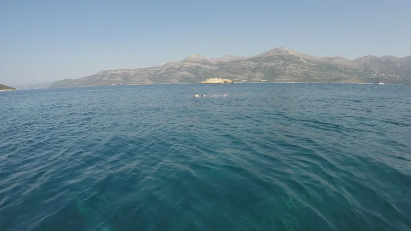  Sparkling turquoise Adriatic Sea with Dubrovnik county in the background, viewed from a private boat near Dubrovnik.